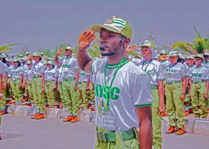 NYSC corps members in uniform on a parade ground — camp and service-year travel windows