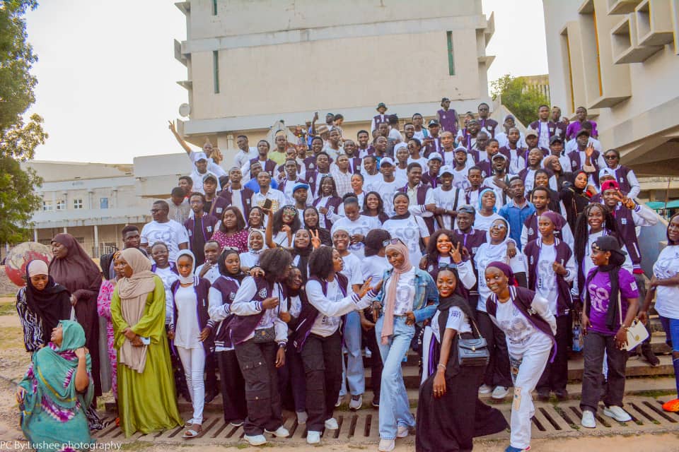 University students gathered on campus steps — school cohort travel and holiday exit periods